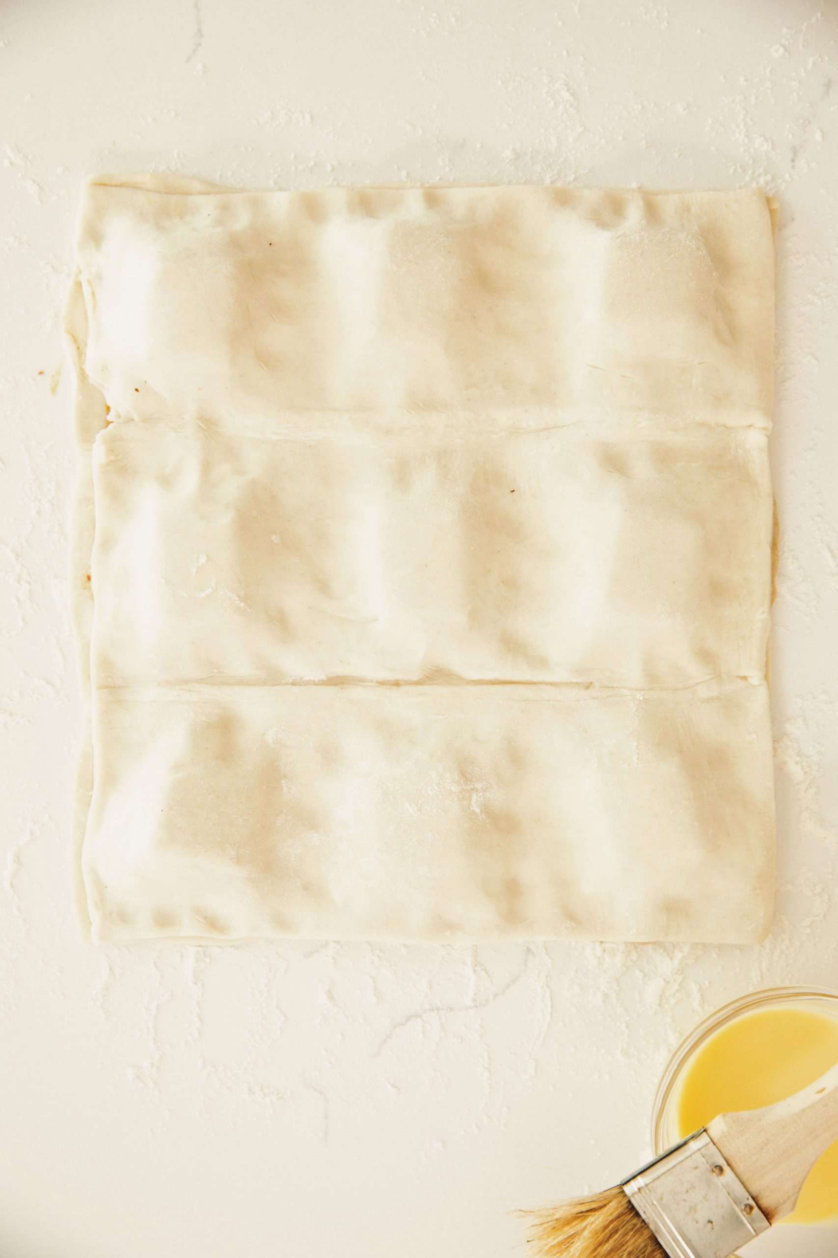 overhead of puff pastry ham and cheese croissants with the top piece of pastry on top